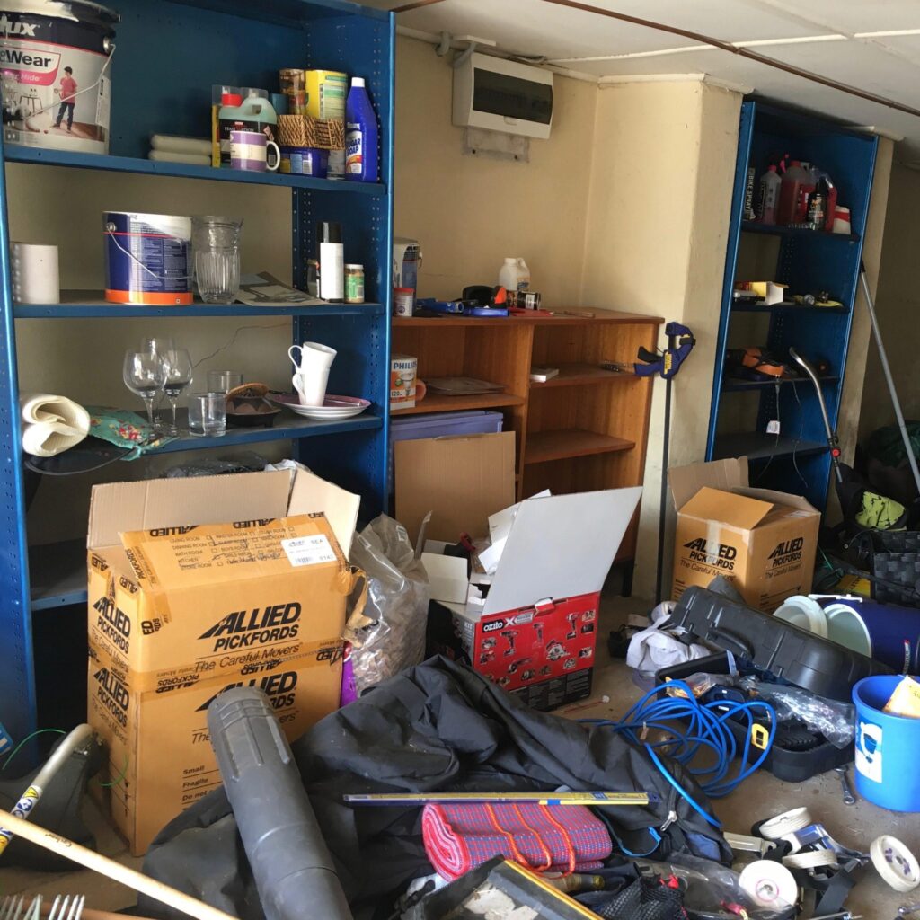Cluttered garage full of household belongings and boxes needing additional storage