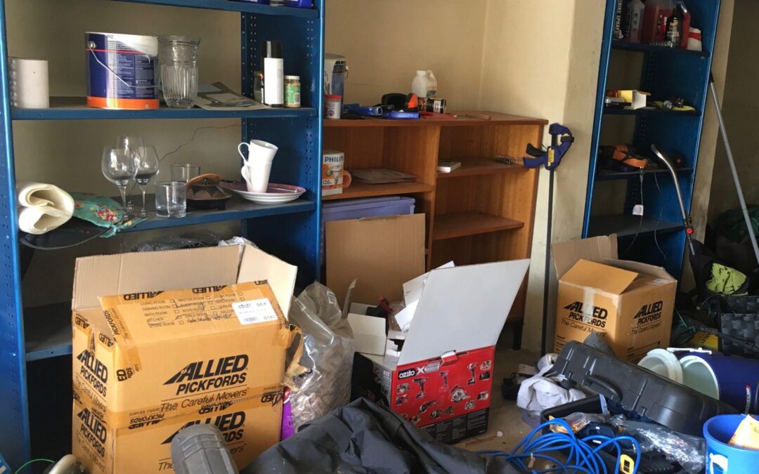 Cluttered garage full of household belongings and boxes needing additional storage